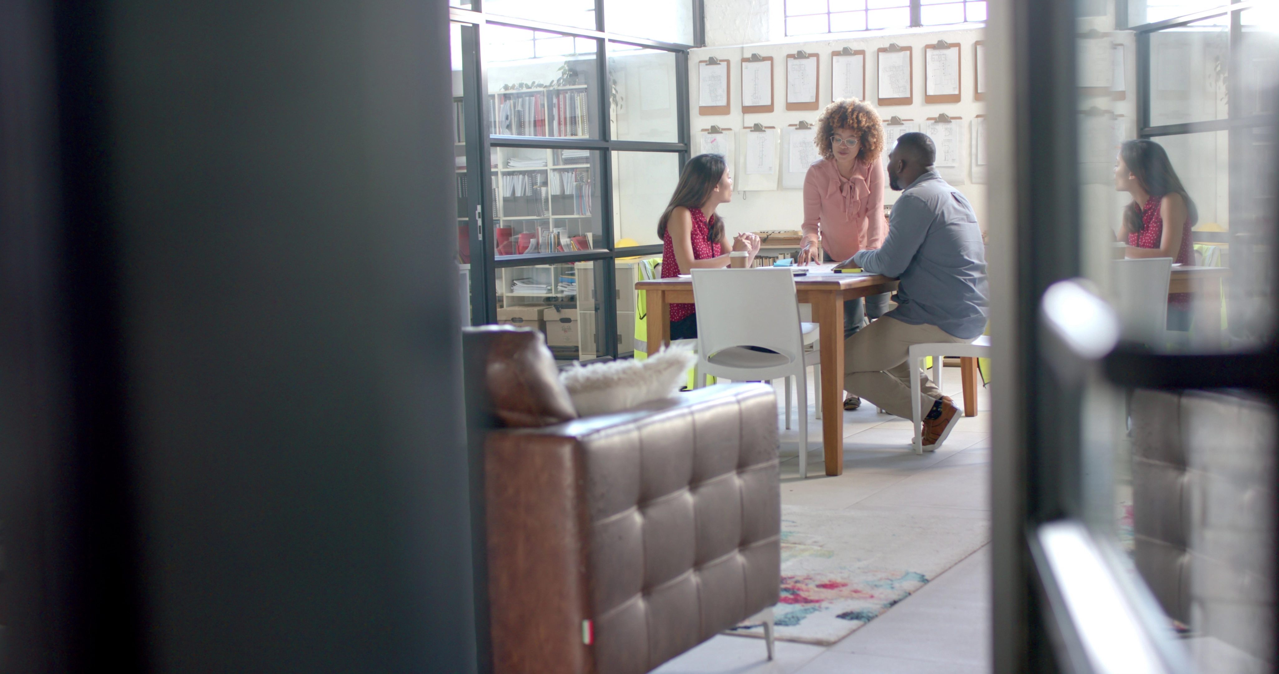 A sourcing agent reviewing production documents with a factory representative